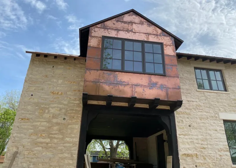 Copper metal panel facade on a stone building for Skylight Installation in West Plains